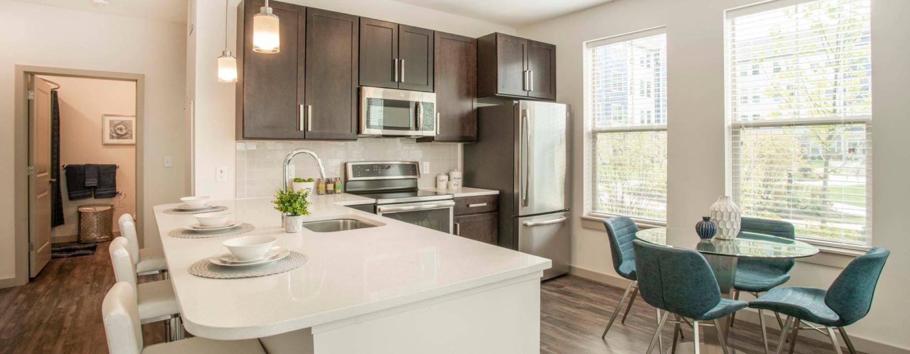 a kitchen with a dining table and chairs